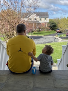 A counselor gently speaking with a family during a home visit in a peaceful neighborhood.