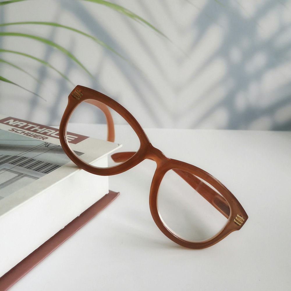 a pair of sunglasses on top of a stack of books