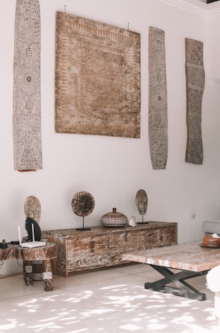 a room with a table and a bench with a painting on the wall