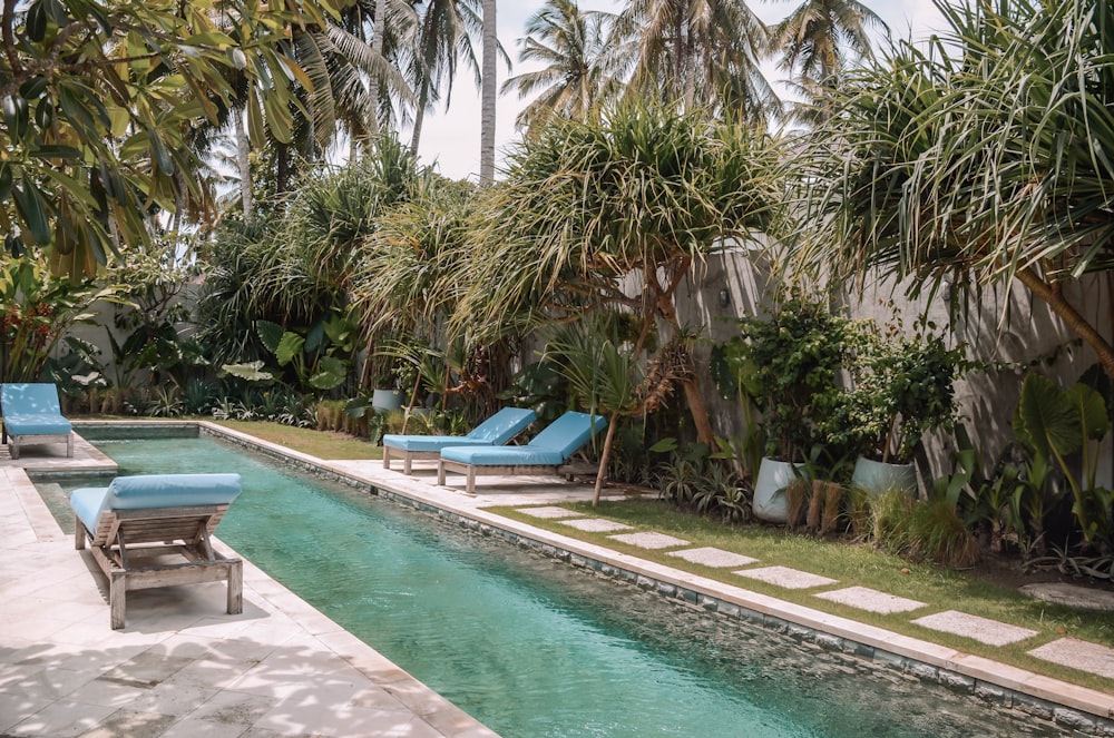 a pool with chairs and a deck