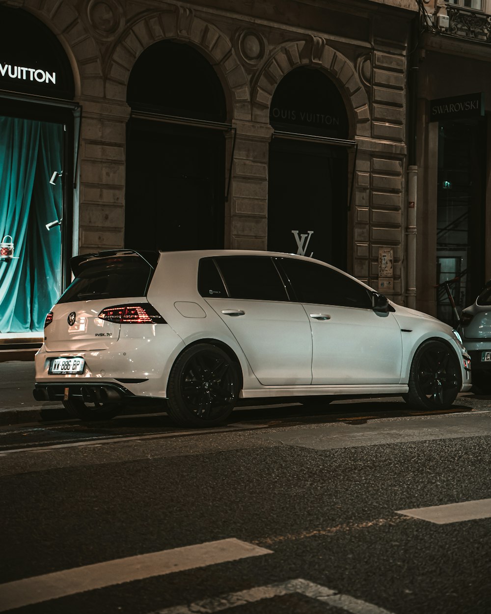 a white car parked in front of a building