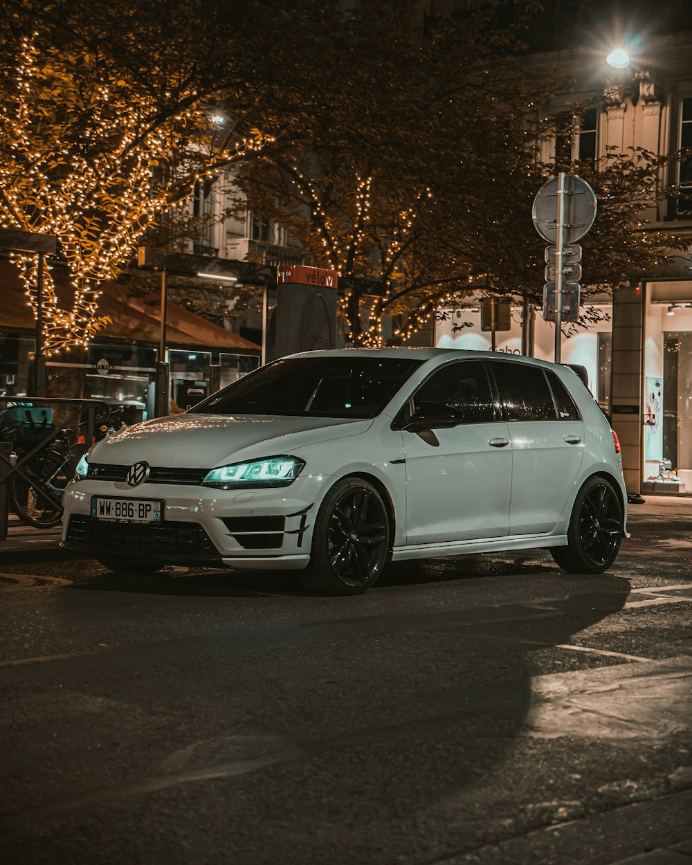 a white car parked on the side of a street