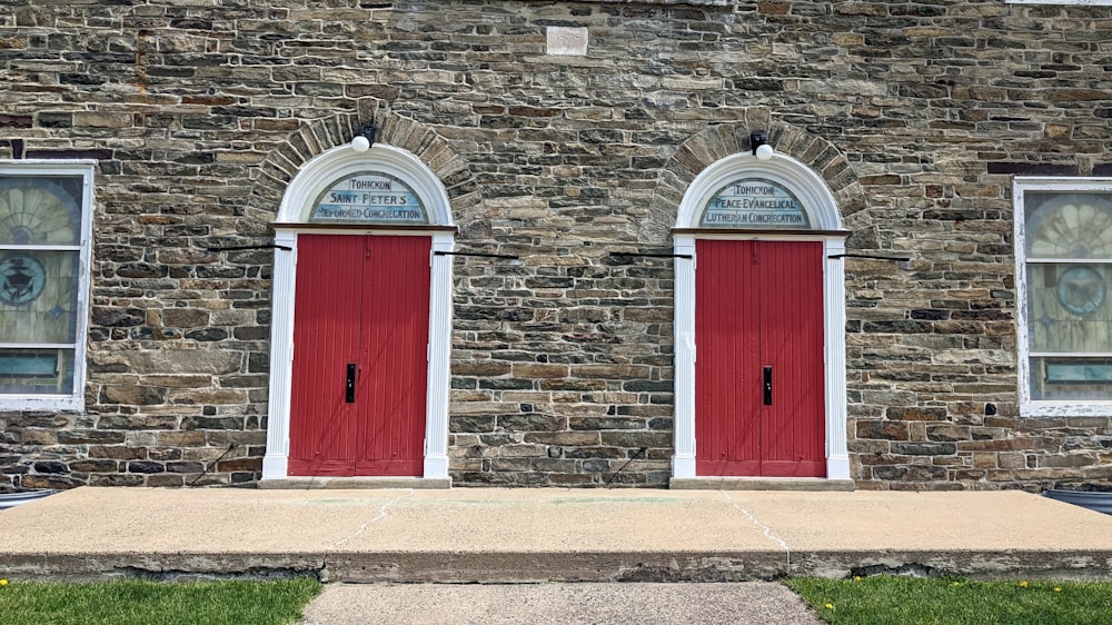 a couple of red doors on a brick building