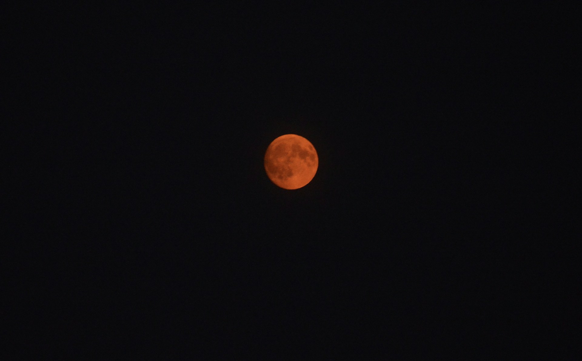a red moon in a black sky