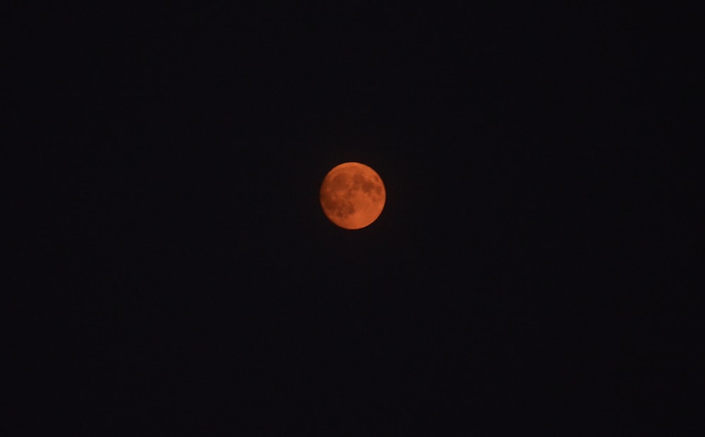 a red moon in a black sky