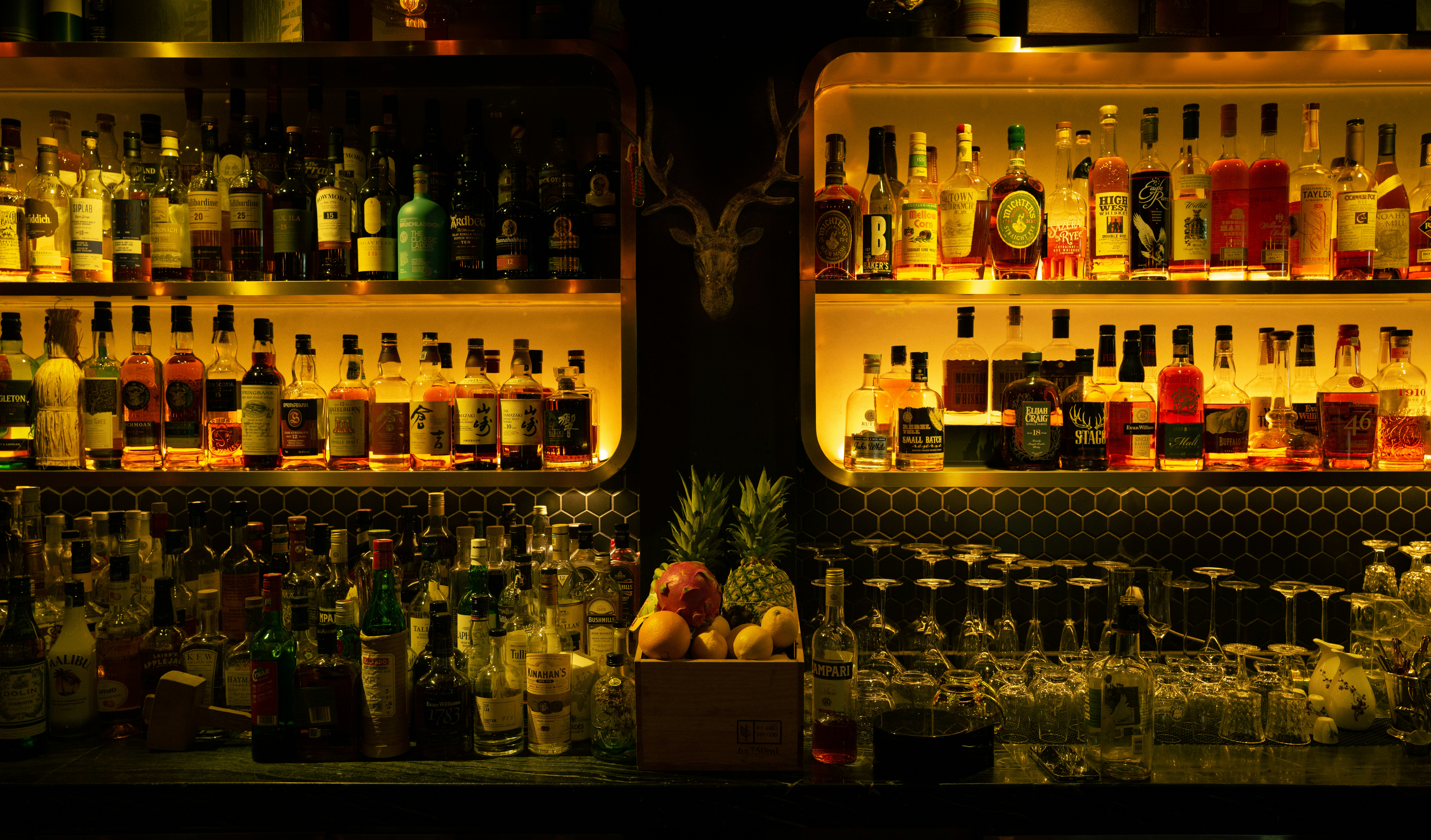 a shelf with bottles of alcohol