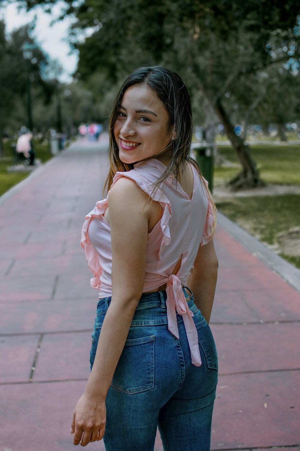 a woman standing on a sidewalk