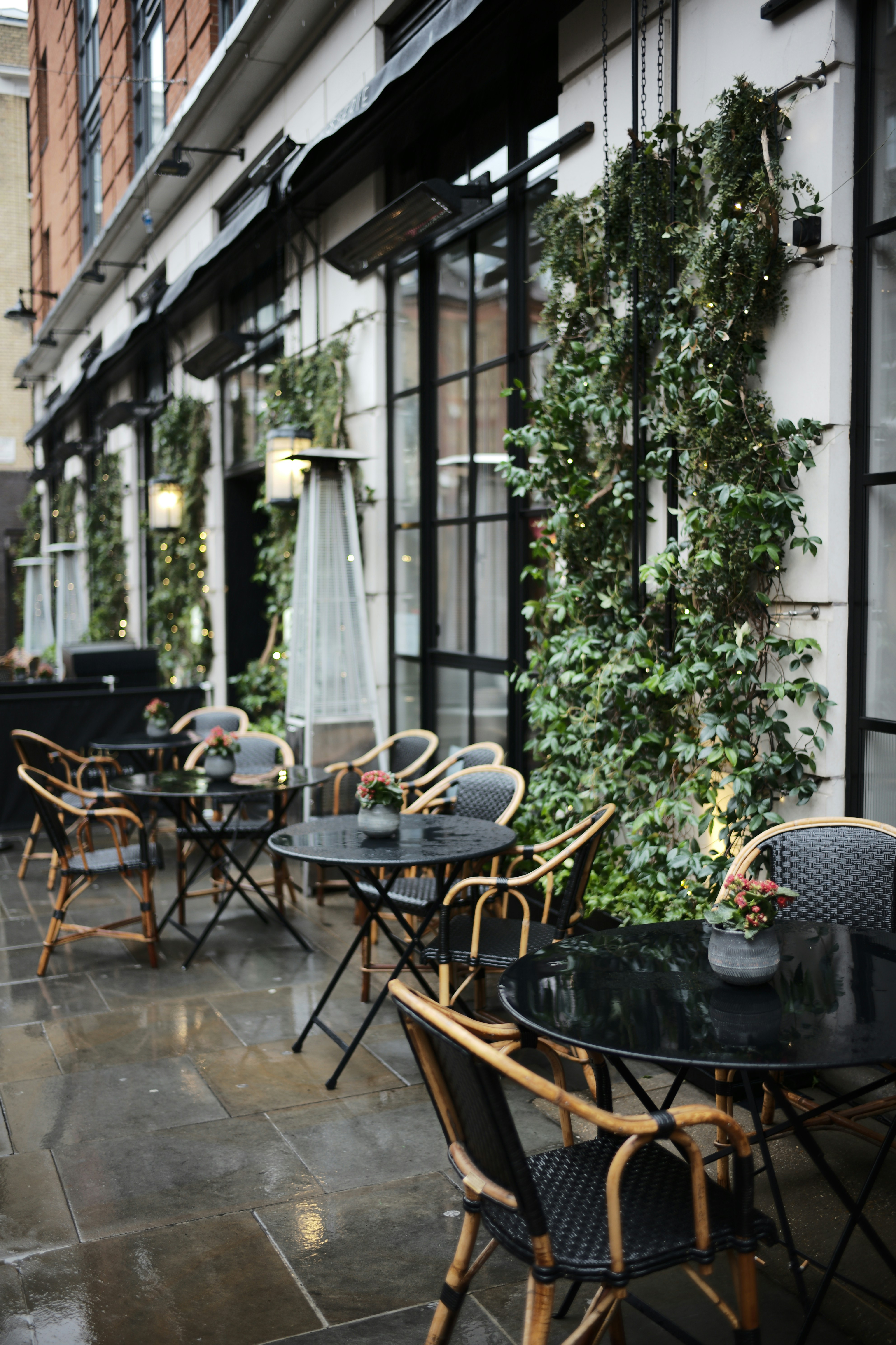 a group of tables and chairs outside a building