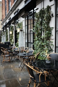 a group of tables and chairs outside a building