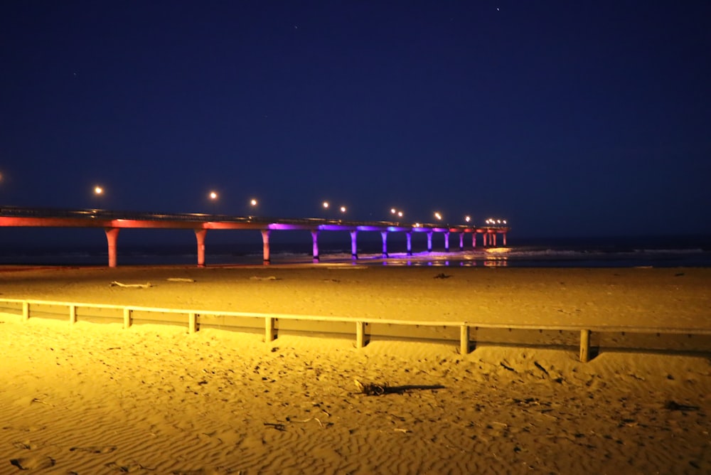 a beach with a bridge in the background