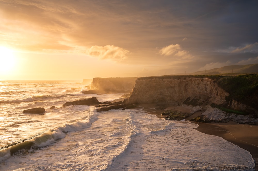 a rocky beach with waves crashing against it