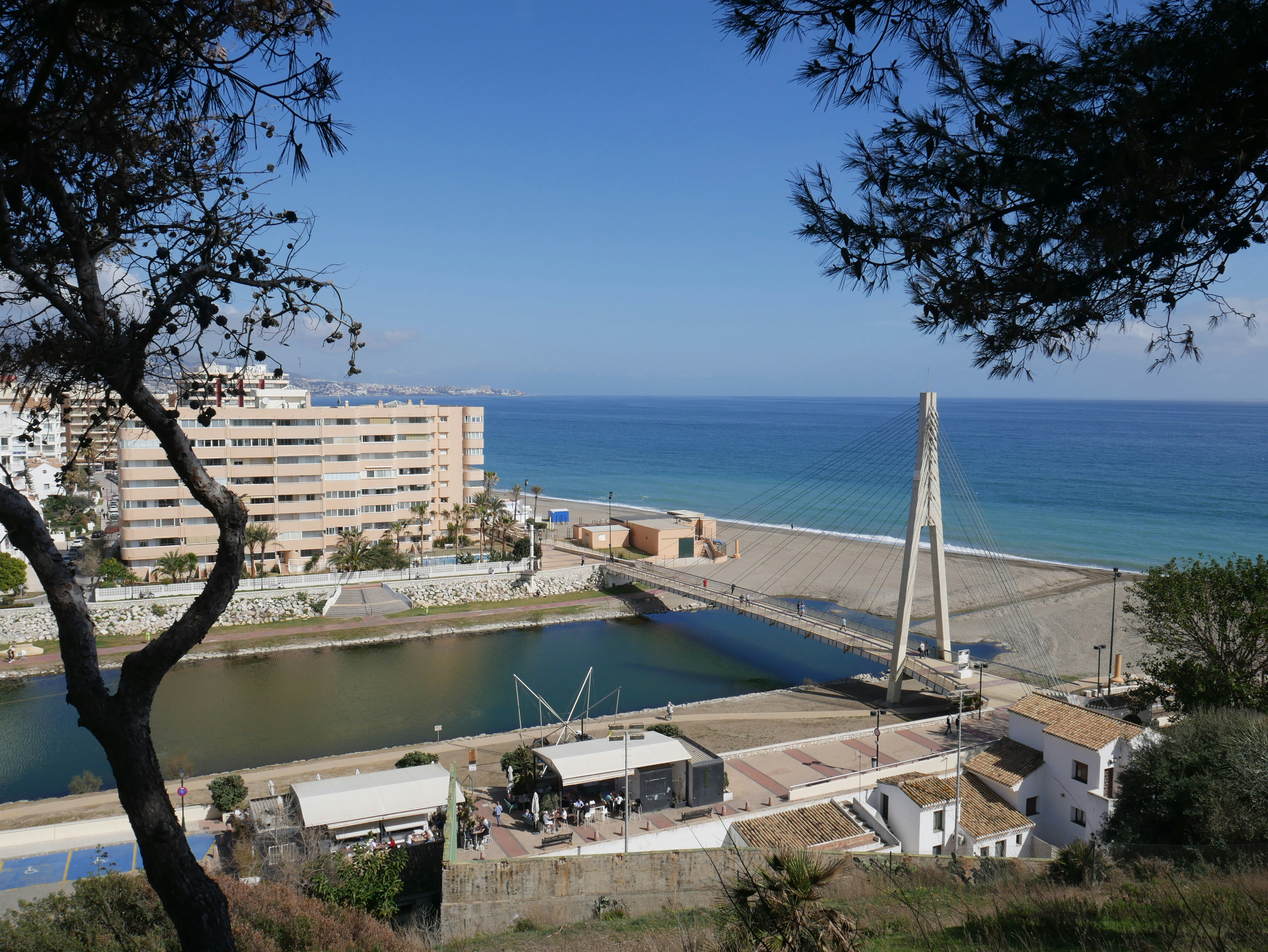 A body of water with buildings and trees around it