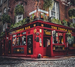 a red building with windows with Temple Bar, Dublin in the background
