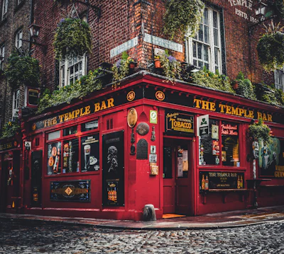 The red frontage of the Temple Bar pub in Dublin, hung with flowers