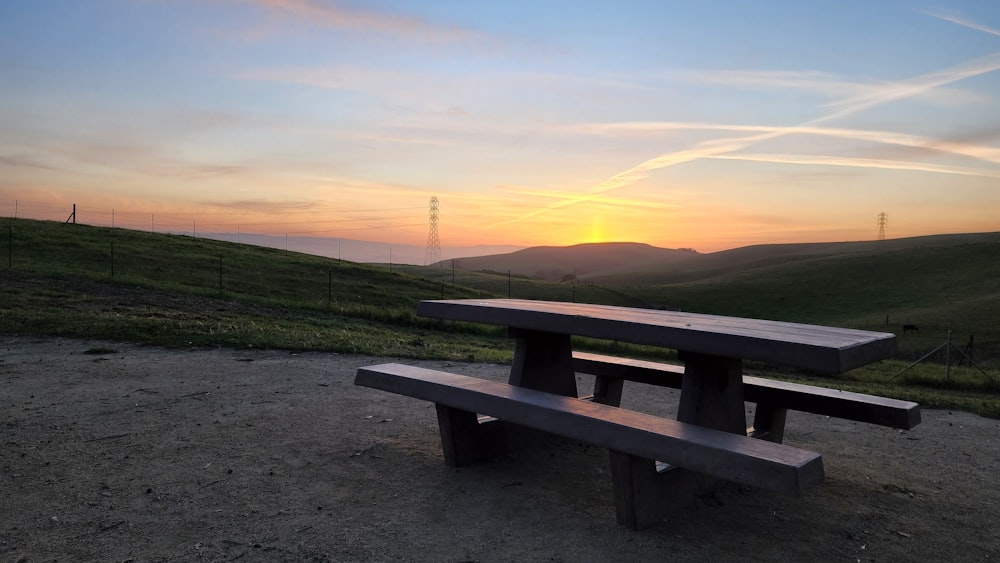 a picnic table on a gravel road