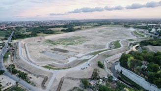 Aerial view of a cleared land area marked for a future road project.