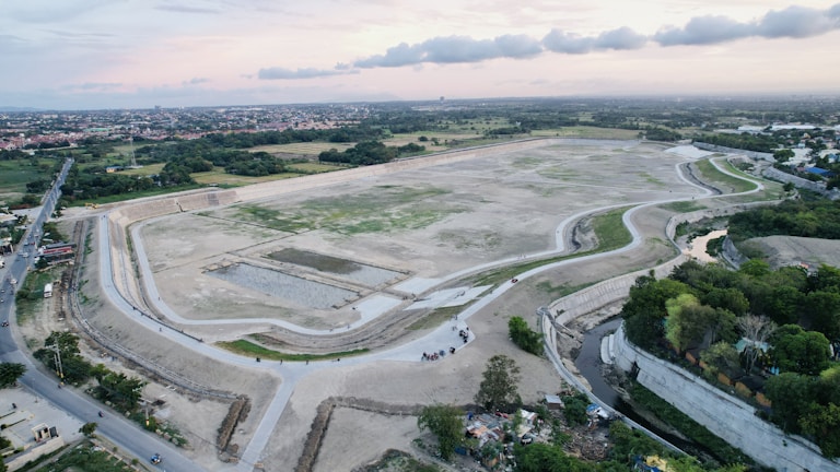 Timelapse-style photo showing progression of a land parcel from raw plot to initial development.