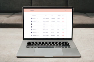 Close-up of hands analyzing cryptocurrency trading charts on a sleek laptop screen.