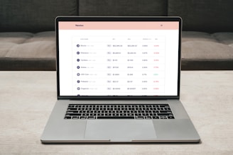 Close-up of a laptop screen showing the Haiti Crypto Exchange dashboard with live crypto prices and transaction history.