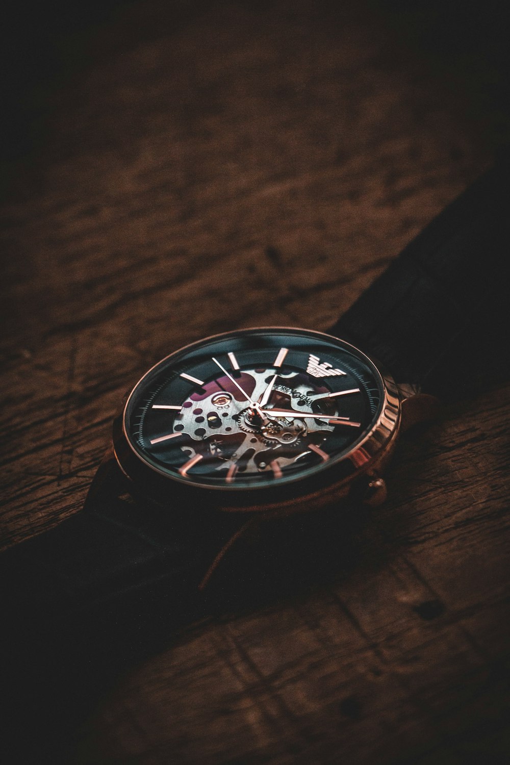 a black and silver compass on a wood surface