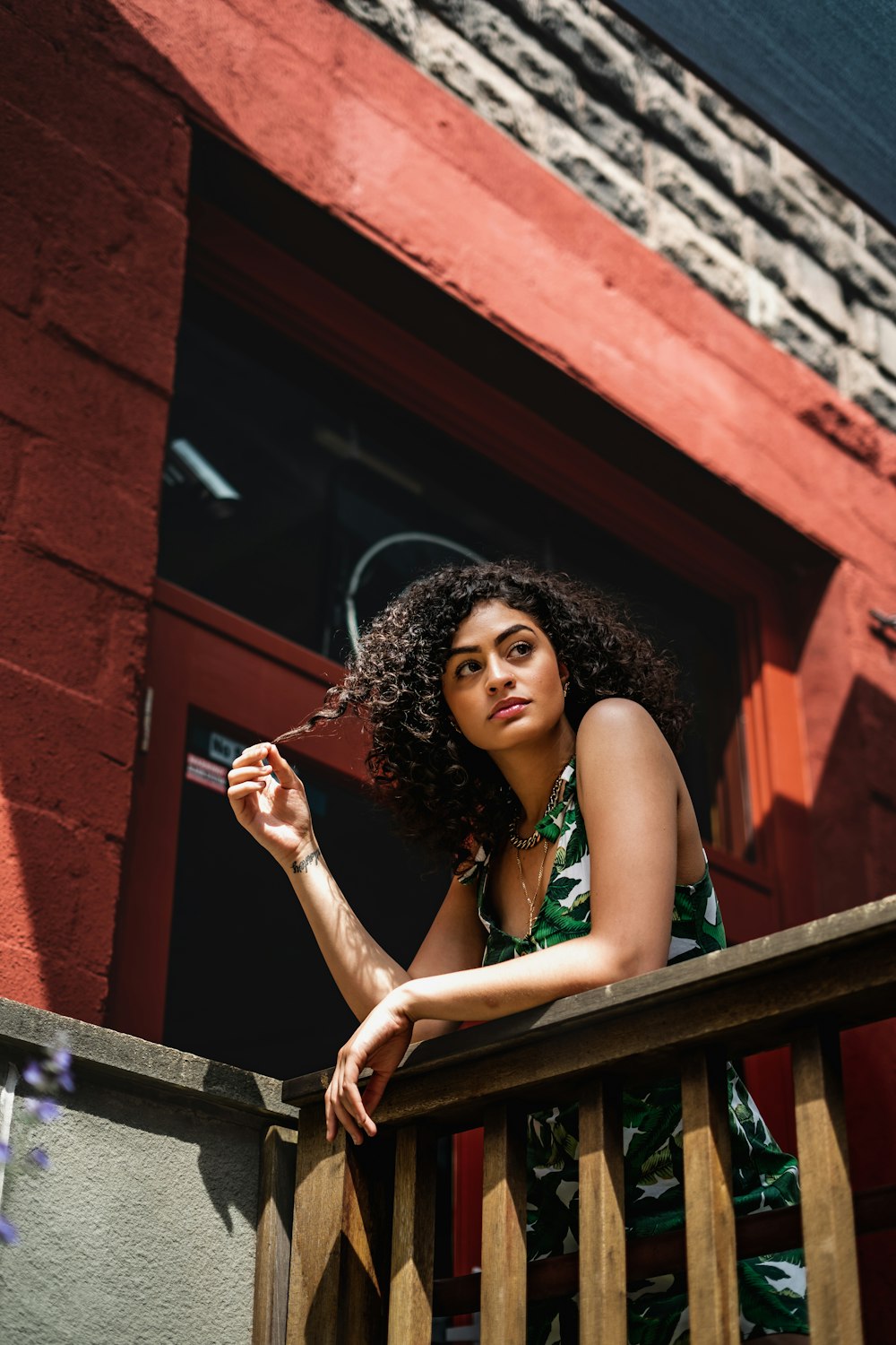 a woman sitting on a fence