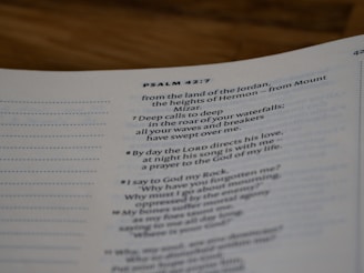 A close-up view of a page from a Bible open to Psalm 42:7. The text is focused on verses discussing spiritual themes, with some text in bold for emphasis. The page has a clean, white background with neatly printed black text.