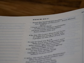 A close-up view of a page from a Bible open to Psalm 42:7. The text is focused on verses discussing spiritual themes, with some text in bold for emphasis. The page has a clean, white background with neatly printed black text.