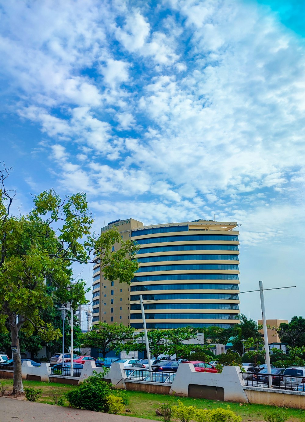 a tall building with cars parked in front of it