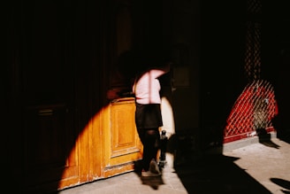 two people standing in a dark room