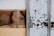 Weathered wooden panels with streaks of white paint and visible scratches, alongside a section with a light brown hue.