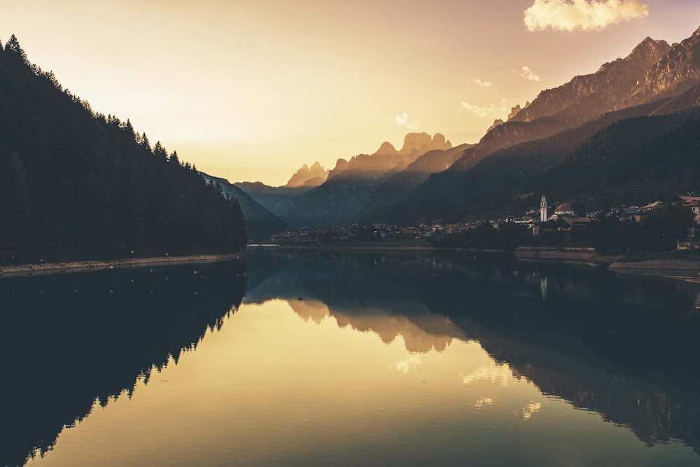 a body of water with mountains in the background