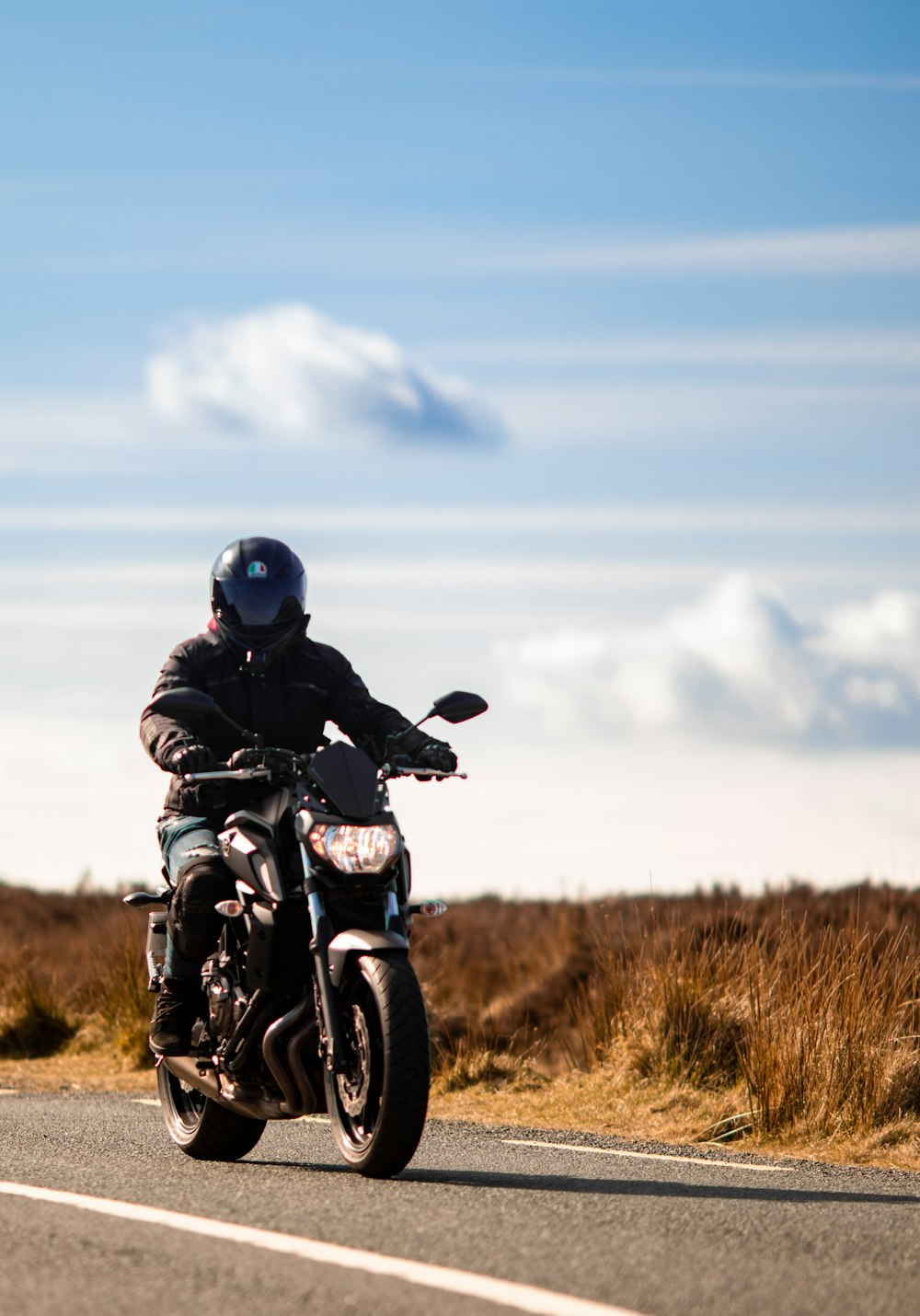 a man riding a motorcycle on a road