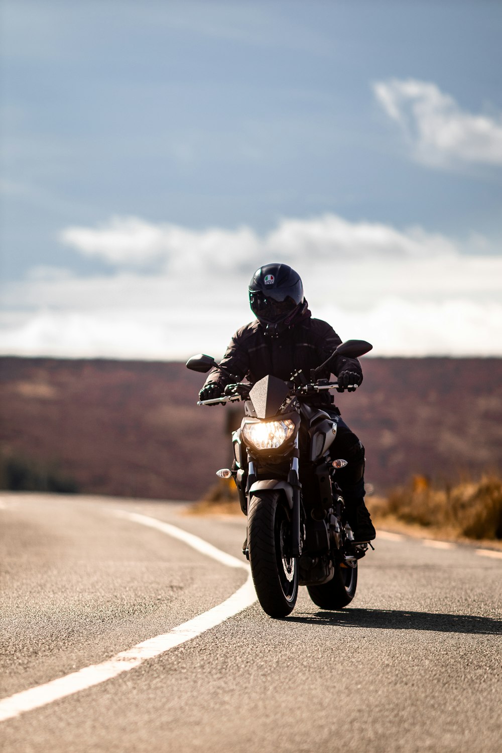 a person riding a motorcycle on a road