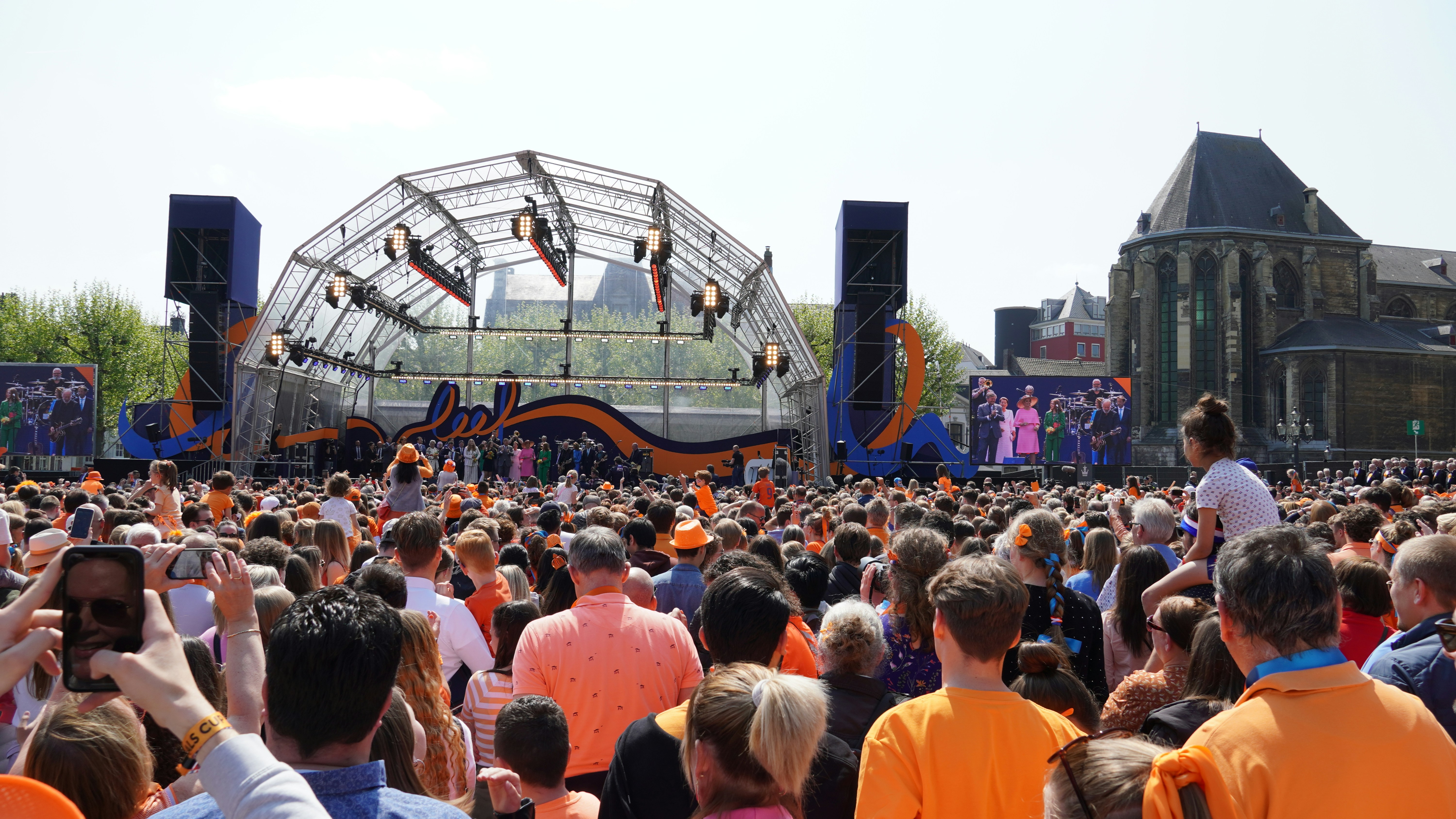 diverse crowd people wearing orange Netherlands street party