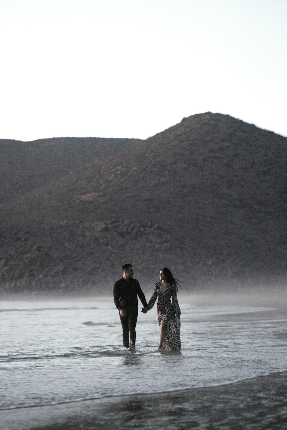 a man and woman standing in water