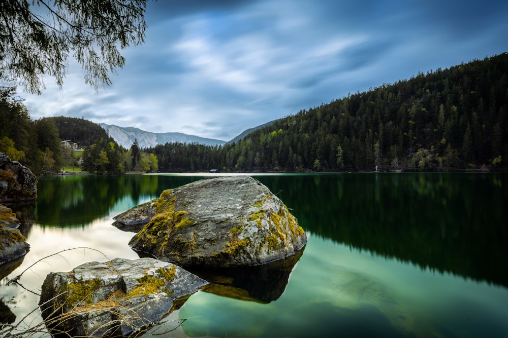 a lake with a rock in the middle