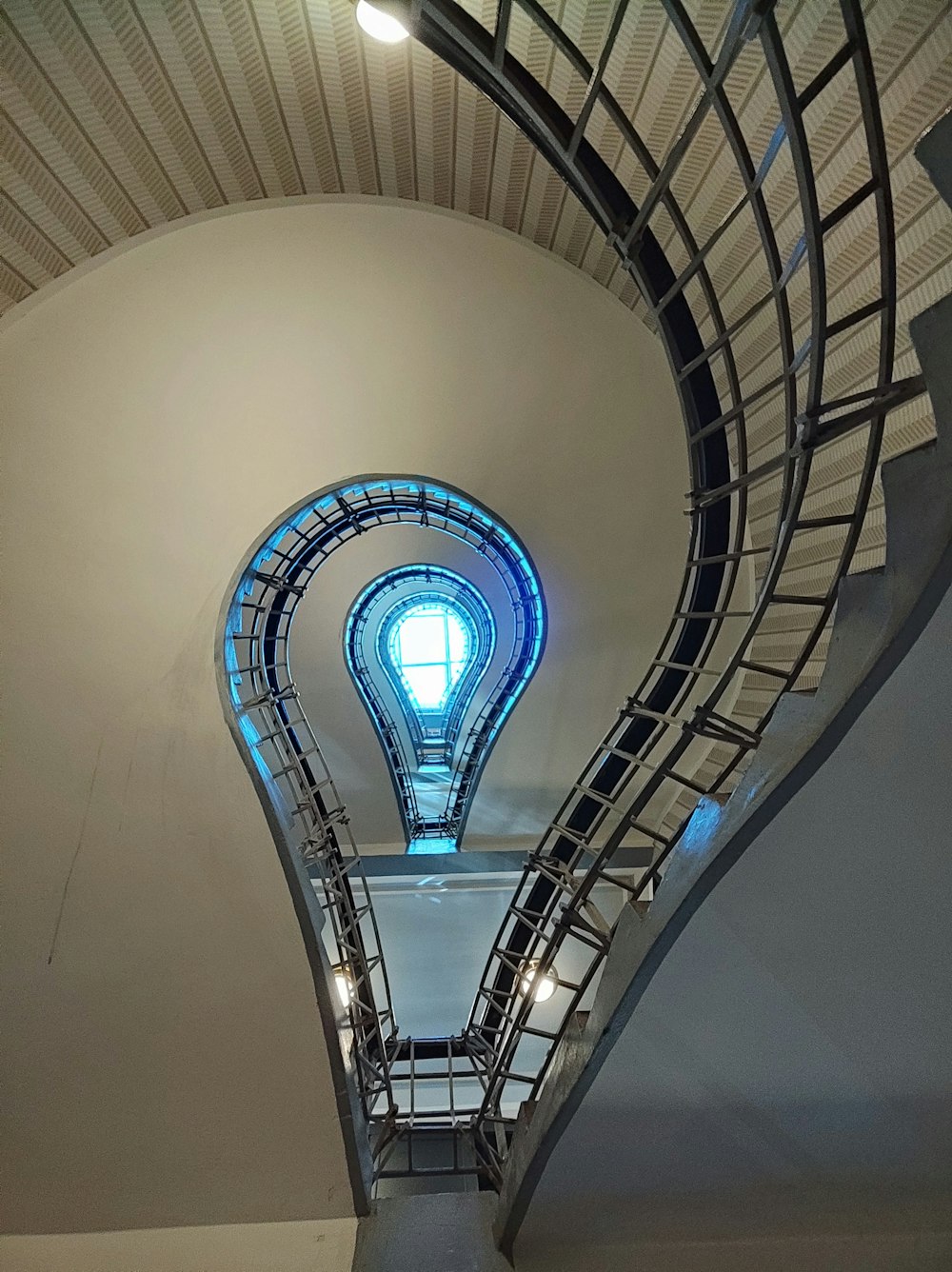 a circular staircase with a blue sky