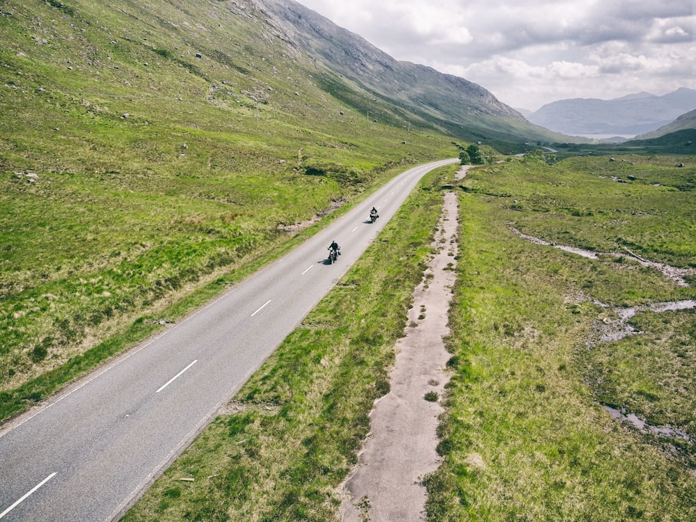 a road with a person on it and a person on the side