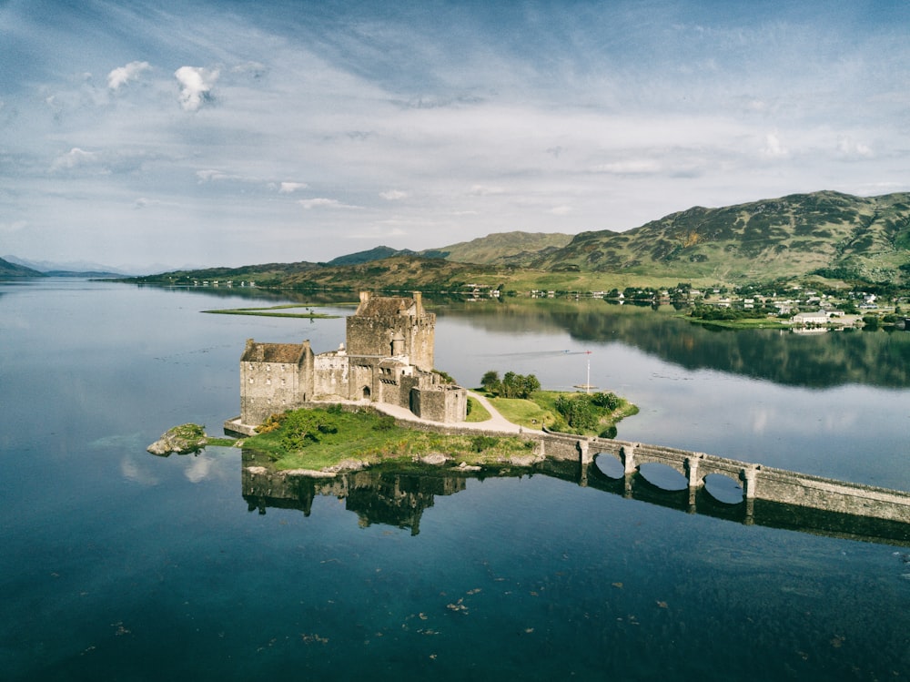 a castle on a small island with Castle Stalker in the background