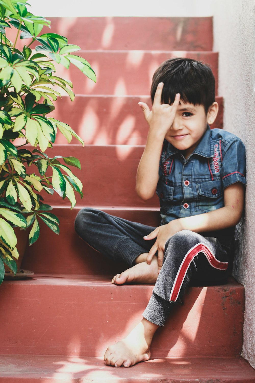 a boy sitting on a ledge