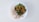 A white plate contains a serving of shredded chicken and a colorful mix of vegetables, including sliced green beans, diced carrots, kidney beans, and corn kernels, arranged in a neat presentation.