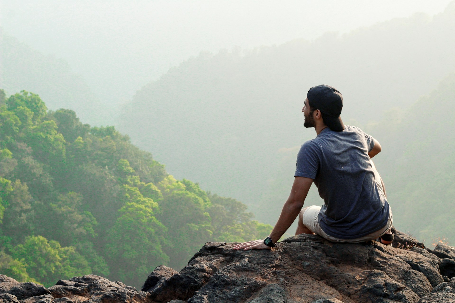 a man sitting on a rock