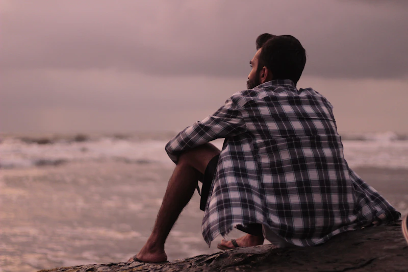 man sitting on the beach