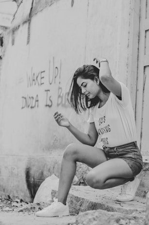 Model posing in Sitara's graphic t-shirt and shorts combo, captured in natural light on a city street.