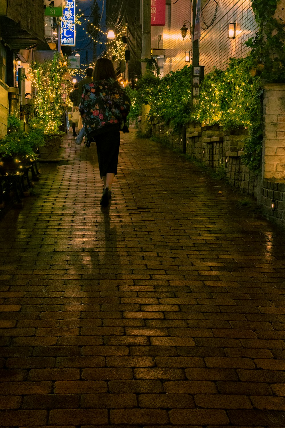 a person walking down a brick street