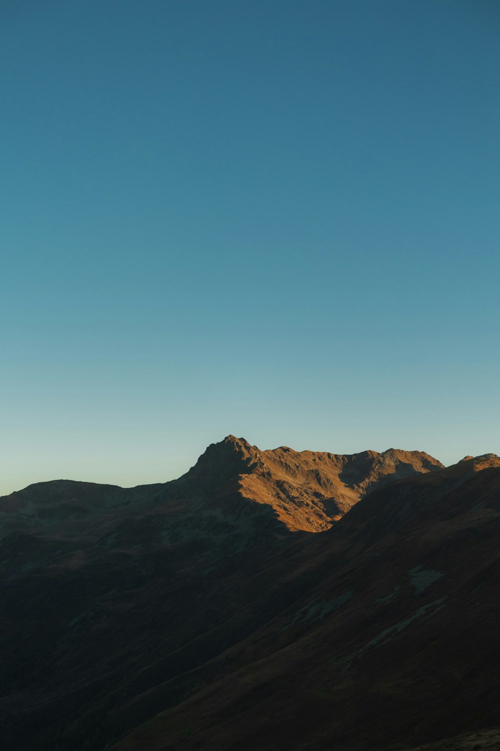 a mountain range with a blue sky