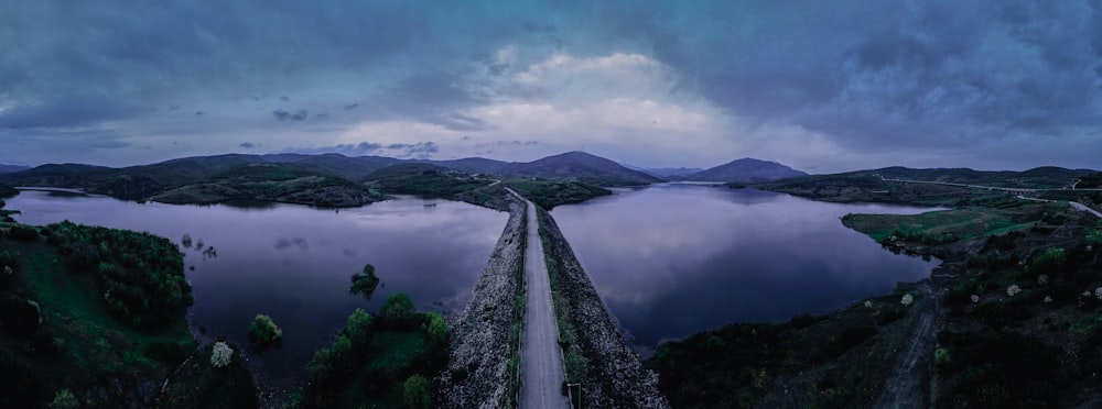 a large body of water surrounded by hills and trees