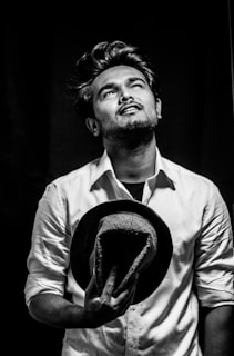 A vintage black-and-white photograph of Bhagat Singh with his iconic hat and intense gaze.