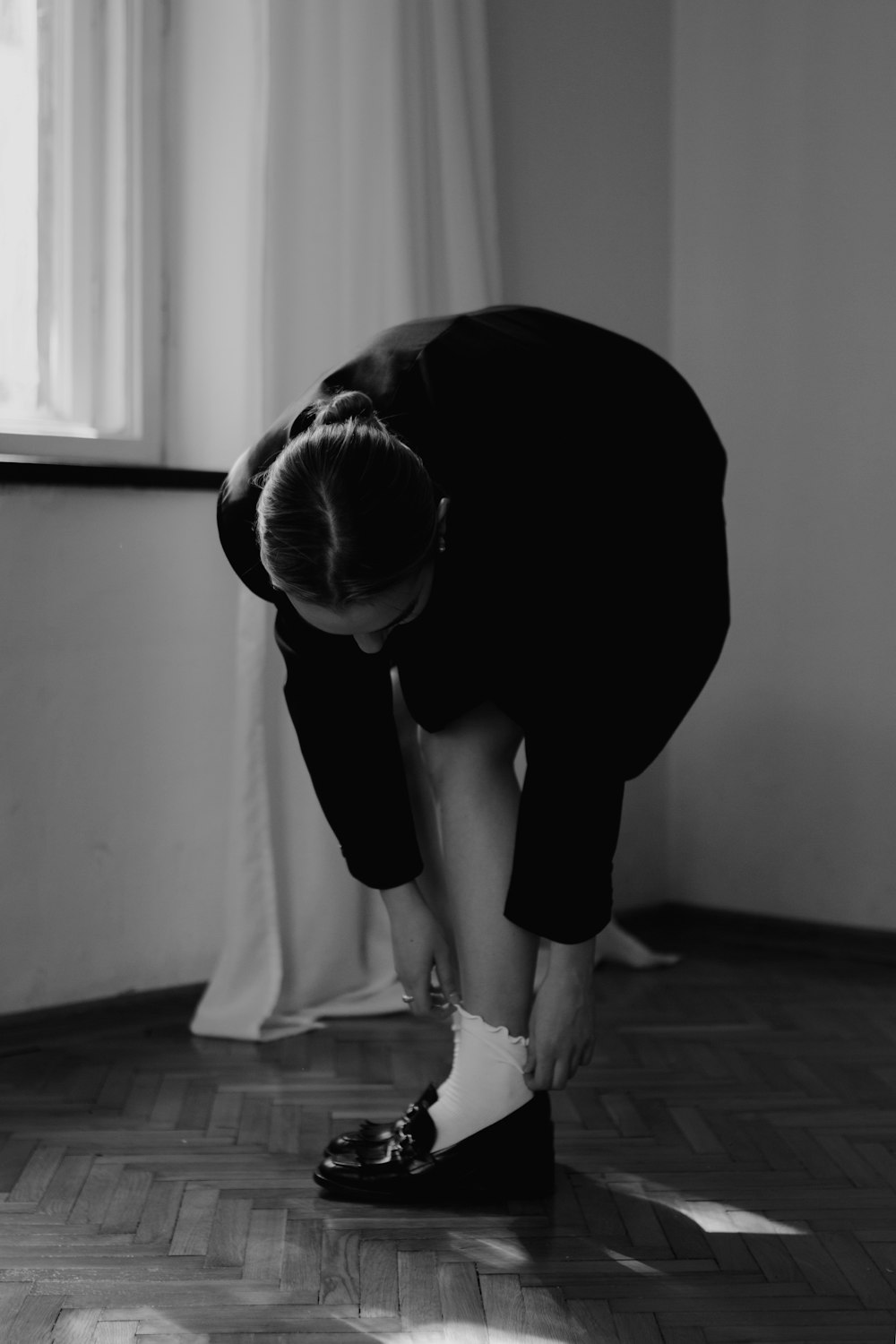 a person bending over to touch a piece of paper