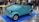 A happy customer standing next to their new microcar.